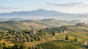 Rolling green hills and mountains of central Italy, representing the landscape shared by Abruzzo and its neighboring regions