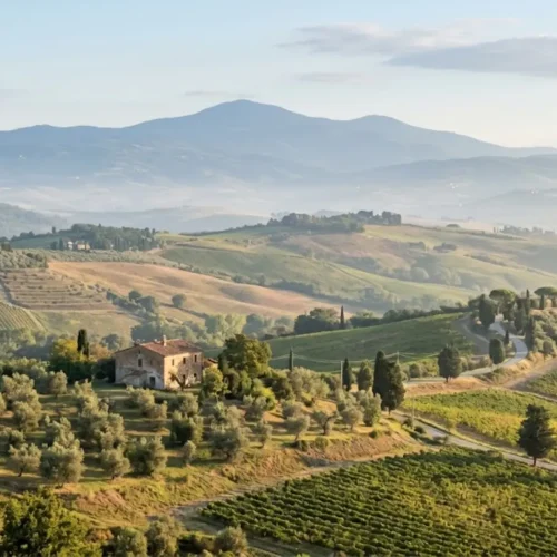Rolling green hills and mountains of central Italy, representing the landscape shared by Abruzzo and its neighboring regions